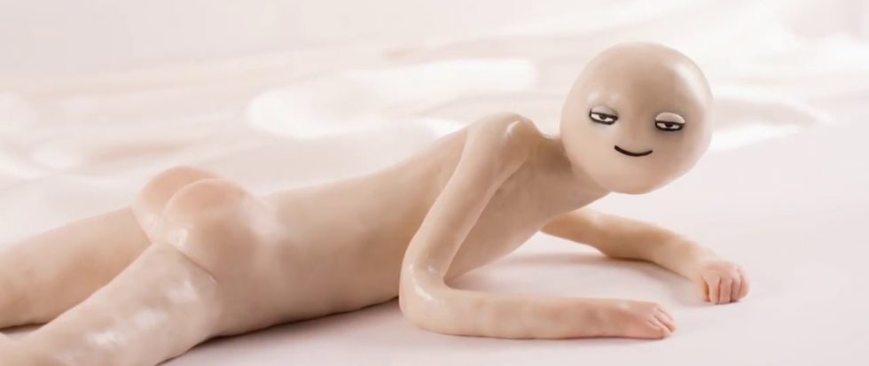 with half lidded eyes, a claymation figure rests naked on a bed but facing skyward. It is a screenshot from Kirsten Lepore's short film Hi Stranger.