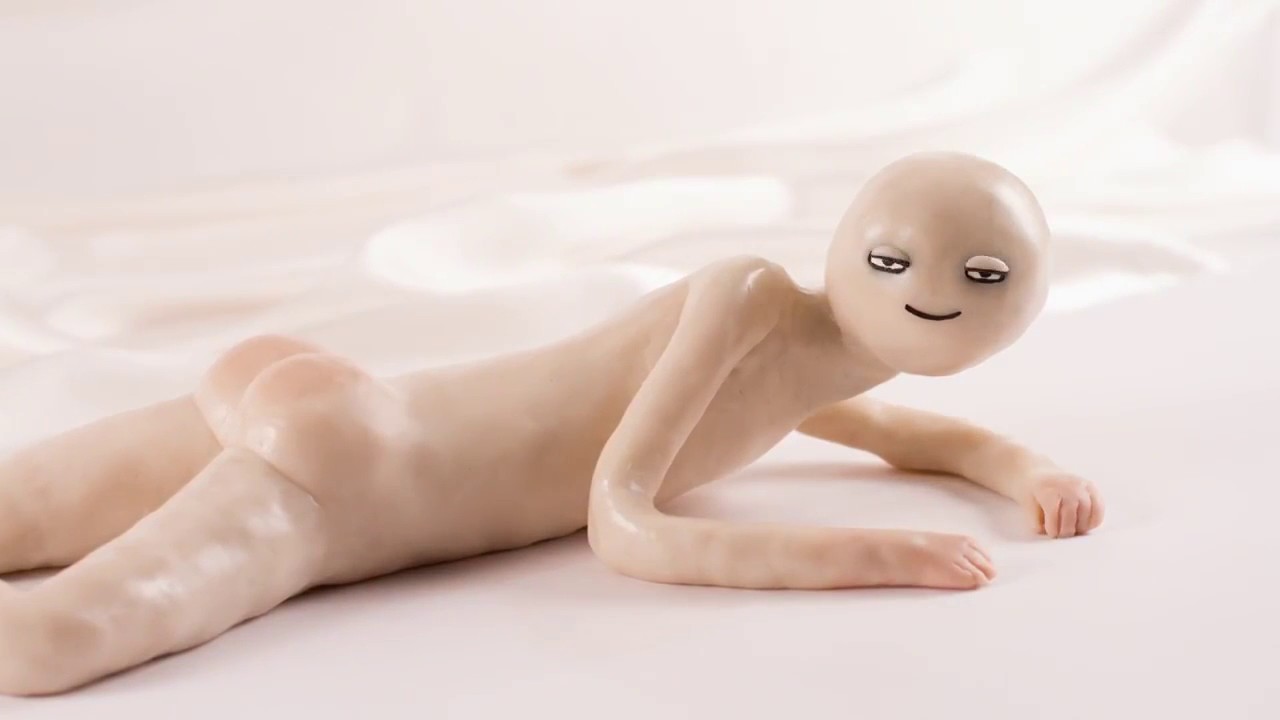 with half lidded eyes, a claymation figure rests naked on a bed but facing skyward. It is a screenshot from Kirsten Lepore's short film Hi Stranger.