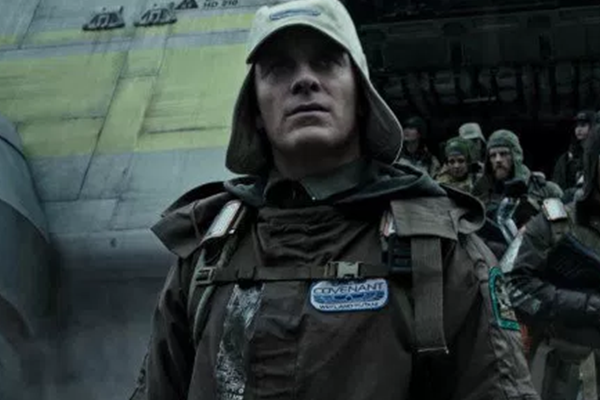 Michael Fassbender in a cap and exploration gear, heading out from a lander in the science fiction film Alien Covenant