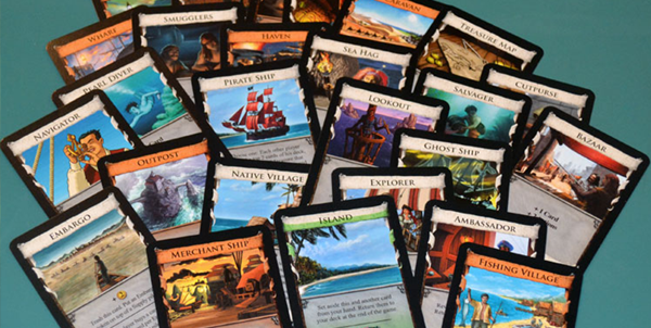 A pile of cards spread across a table, from the deck building game Dominion