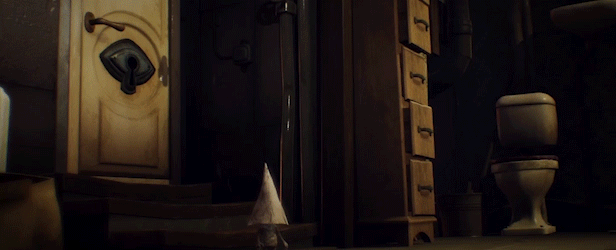 a series of coneheaded gnomes hiding in a room, they move quickly when the door opens to reveal two long and creepy arms. This is an image from the game Little Nightmares