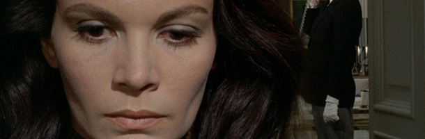 a brunette woman with a stern face and defined chin takes up the left side of the camera. This is a still from the film A Lizard in a Woman's Skin