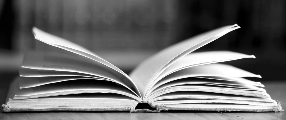 A black and white image of an open book.