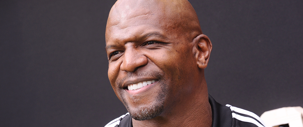 Smiling, actor Terry Crews looks to the left.