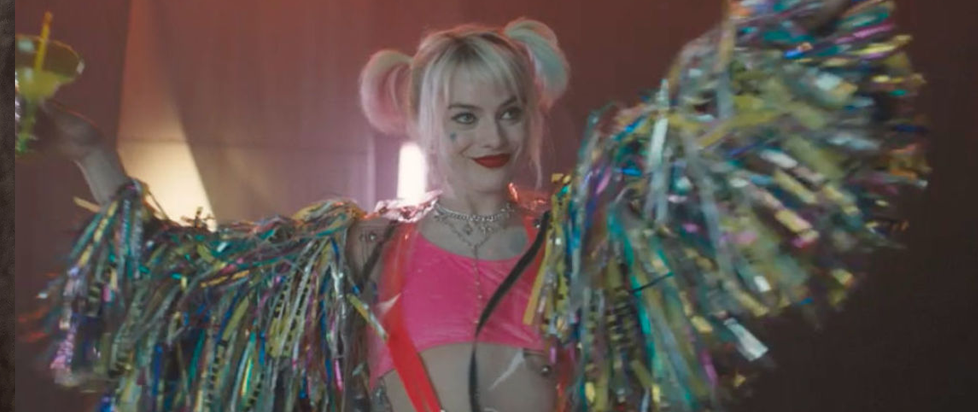Harley Quinn with a caution tape jacket raising her arms
