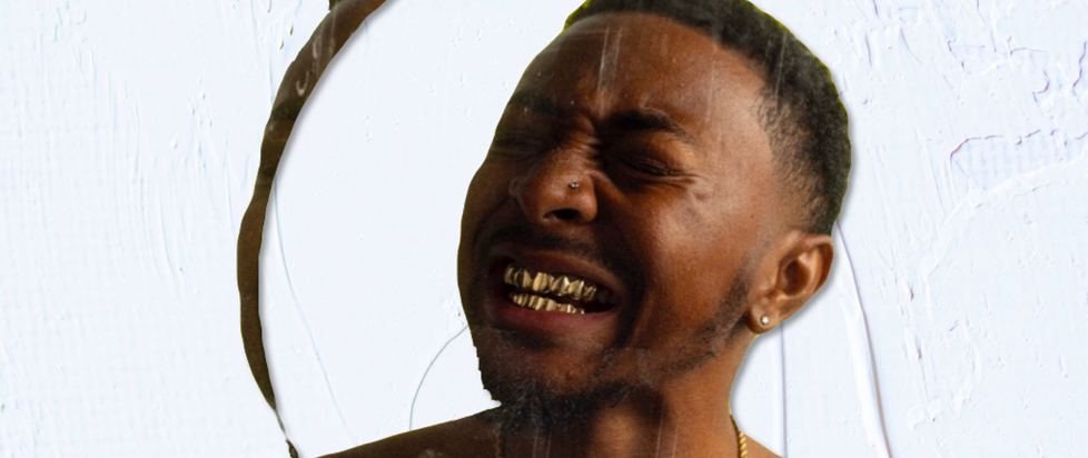 A man with gold teeth within concentric circles.