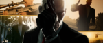 centered, the bald head of Agent 47 holding a handgun in a gloved fist, surrounded by images of himself doing other rad action-movie like things.
