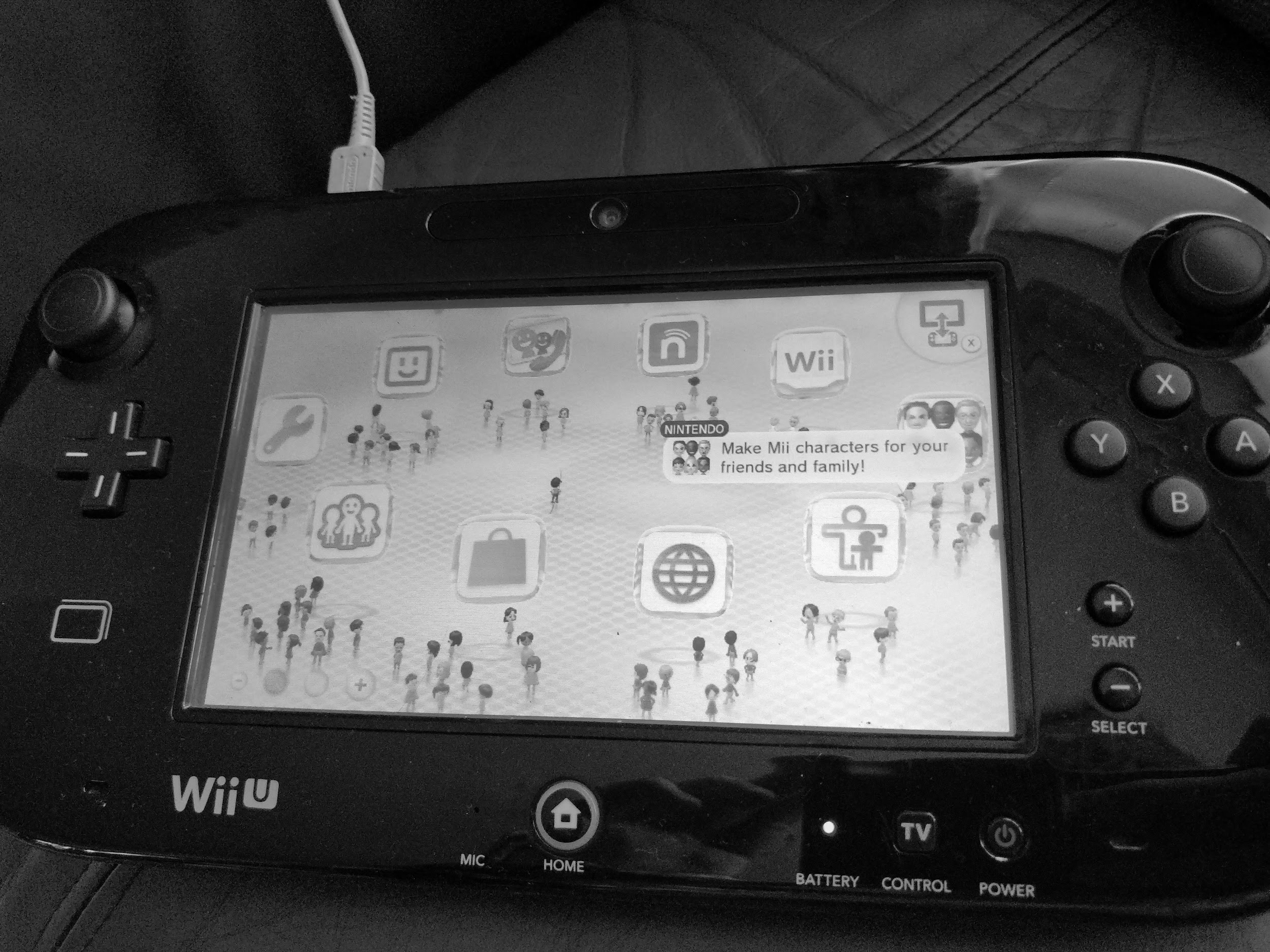 The scene of the Wii U menu on a black and white Wii U 