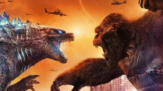 Godzilla, a giant prehistoric lizard, faces off against Kong, a giant ape. Helicopters fly around their heads, tiny in comparison.