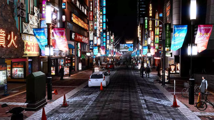 A night street in Tokyo, lined with bright lights and illuminated billboards.