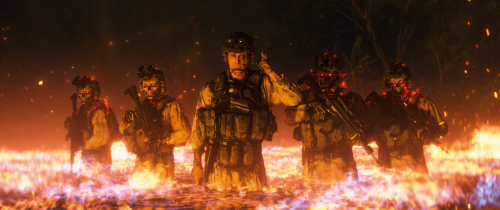 Five soldiers in heavy gear and camouflage fatigues wade through what looks like a pool of fiery lava.