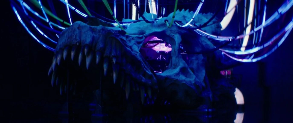 Ghidorah's skull from King of Monsters, lit up with leds and strung up with wires.