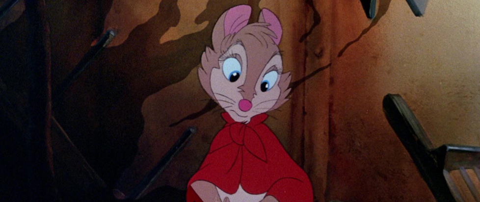 A still from The Secret of NIMH featuring Mrs. Brisby looking worried. She is a light brown field mouse with large eyes. She wears a red cloak.