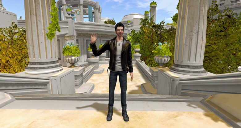 A male Second Life avatar stands on the stone steps of what looks like a Greek amphitheater. He waves awkwardly.