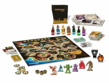 The game Horrified: American Monsters laid out with the board, assorted minis, cards, and other elements