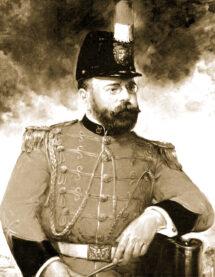A sepia-toned photograph of John Philip Sousa, a bearded man wearing the militaristic uniform and hat of a marching band conductor.