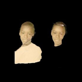 Two torn photographs of a young Black boy in a white t-shirt on a field of solid black. One of the photos shows just the boy's head.