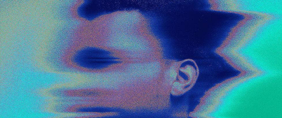 A side-profile photograph of Denzel Curry that is blurred and pixelated as if seen on a snowy TV screen.