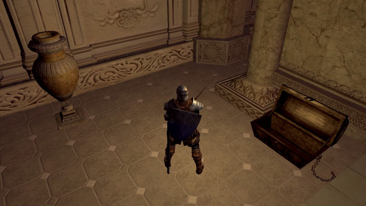 In a screenshot from Dark Souls, a knight stands next to an open, empty treasure chest.