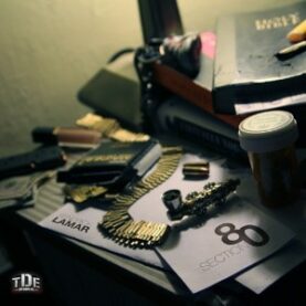 Cover art for Kendrick Lamar's Section .80, depicting a cluttered table with a Holy Bible, a pipe and a bandolier of rifle rounds, among other things.