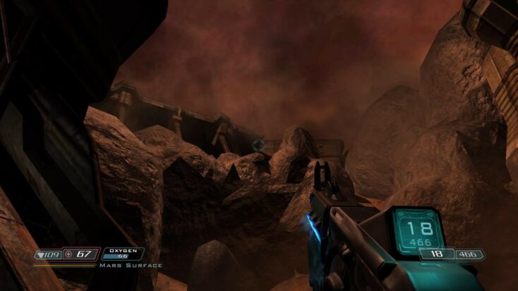 A screenshot from DOOM 3 showing a first-person perspective of a base high atop a rocky cliff on Mars, the landscape clearly influenced by newer images from recent Mars expeditions.