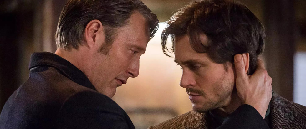 In a still from NBC's Hannibal, Hannibal Lector holds the back of Will Graham's neck, the two men's foreheads almost touching.