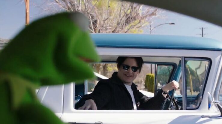 Musician Jack White and Kermit the Frog converse through the rolled down windows of their respective cars while stopped at a traffic light.