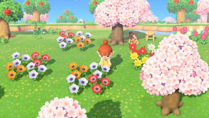 A player character in Animal Crossing: New Horizons tends to wild flowers beneath pink-hued cherry blossom trees.