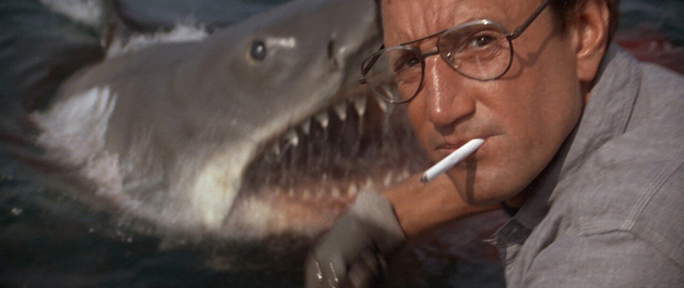 A still from Jaws featuring actor Roy Scheider in front of the mechanical shark puppet.