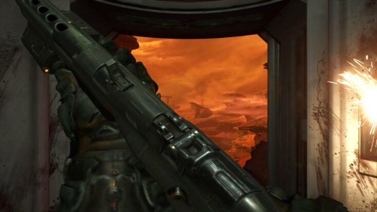 In a screenshot from DOOM 2016, the player holds a rifle in both hands while looking out of a window at the red landscape of Mars.