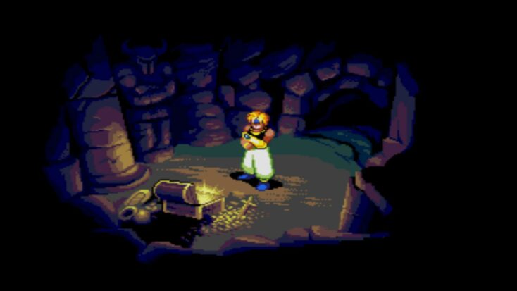A videogame adventurer stands in the center of a dark cavern, staring into an open treasure chest which seems to be dimly lighting the room.