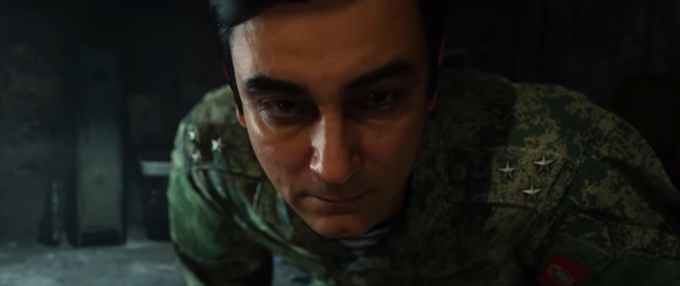 Screenshot from Call of Duty Modern Warfare 2019, during the torture interrogation scene, where the military made is in the face of the player camera looking stern and cruel