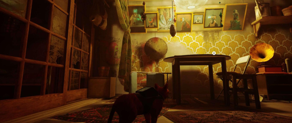 A screenshot from Stray, featuring a cat with a backpack staring at a wall loaded up with photo portraits of various robots, a straw hat, an old timey Victrola record player, and a mish mash of other cultural patterns on the walls and floor