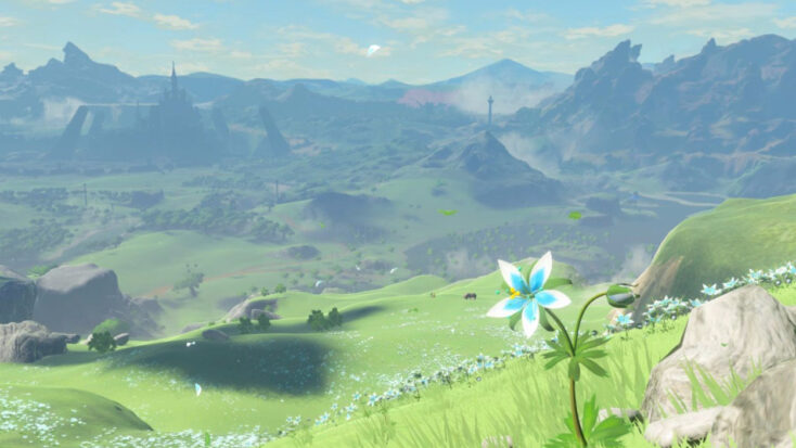 A solitary Silent Princess flower bends gently in a breeze in a grassy Hyrulian valley in this screenshot from Breath of the Wild.