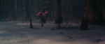 Screenshot from the trailer for Swamp Thing, where a swamp is covered in dry ice fog as the titular Swamp Thing carries a scantily-clad Barbeau through the moist forest