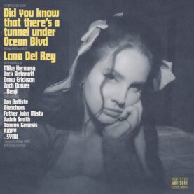 The album cover for Lana Del Rey's Did You Know that there’s a Tunnel Under Ocean Blvd, featuring a moody grayscale photo of the singer leaning her face upon her hand.