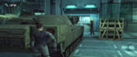 In a screenshot from Metal Gear Solid, Snake hides behind a tank as a henchman searches for him, gun drawn.