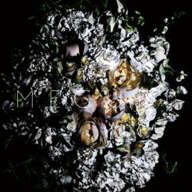 Cover art for the single Meguri by World's End Girlfriend, a collage of many flowers in black and white with a few in color at the center