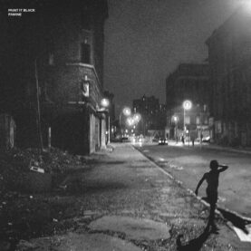 The album art for Paint it Black's Famine, featuring a black and white photograph of a run-down city street. A lone child-sized figure walks along the sidewalk.