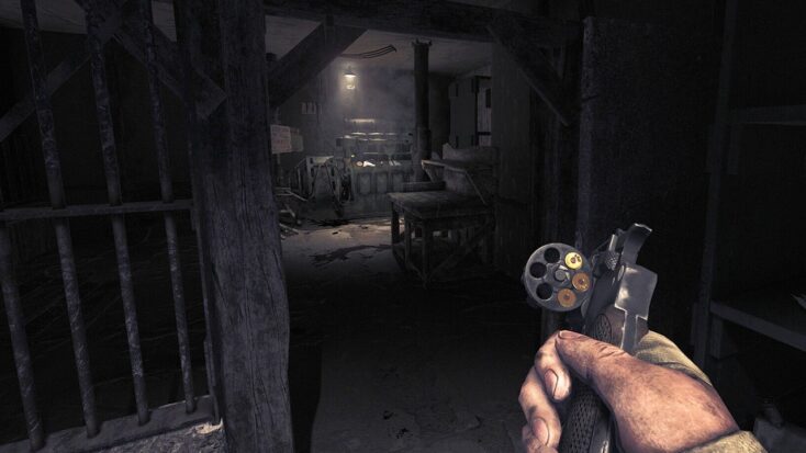 A screenshot from Amnesia: The Bunker shows the player protagonist in the middle of reloading their revolver.
