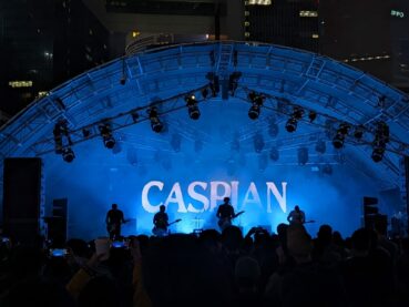 A photograph of the band Caspian by the author. It's dark and the musicians are almost entirely silhouetted with the fog machine going at full speed