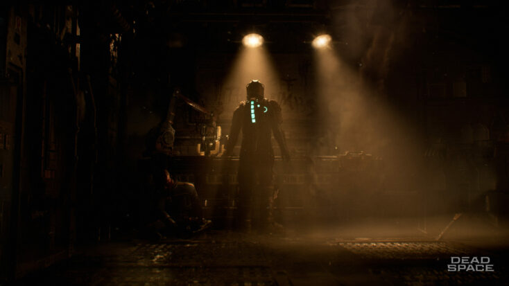 Isaac steps into a dim pool of light, darkness filling the space beyond its edges in a screenshot from Dead Space.