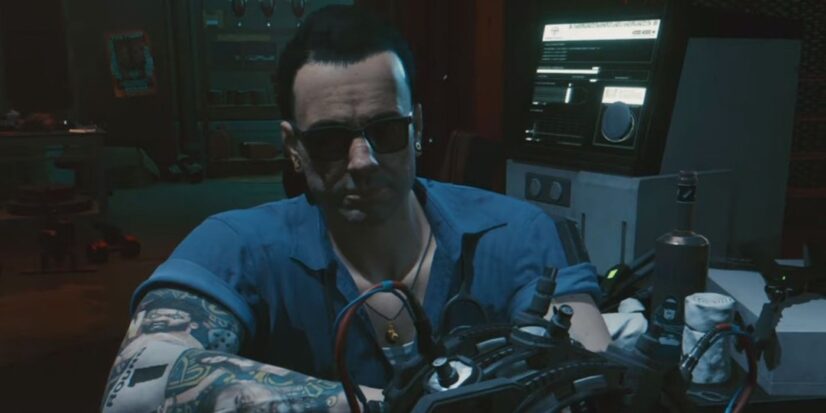 Ripperdoc Viktor Vektor from Cyberpunk 2007. He wears a blue button-up shirt and sunglasses indoors and is there for all your cybernetic implanting needs.