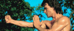 A shirtless Patrick Swayze practices his fightin' moves in a still from Road House.