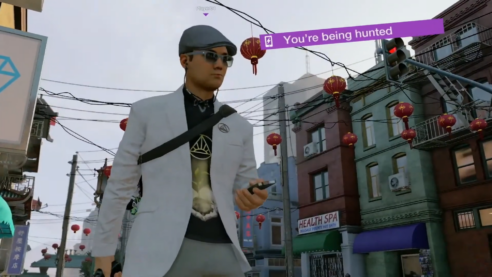A screenshot from Watch Dogs 2 with Player 4 in a sharp suit looking at their phone with the warning YOU ARE BEING HUNTED