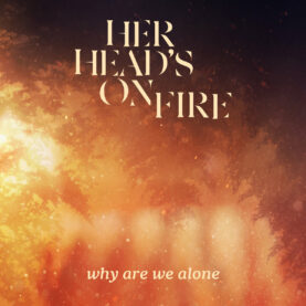 The cover of Her Head’s On Fire's "Why Are We Alone" features a smoldering forest fire seen from the ground up.