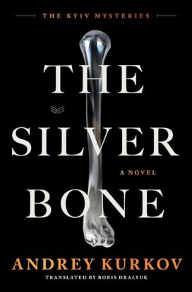 The cover Andrey Kurkov's The Silver Bone shows a shiny silver femur floating in a dark field of black.