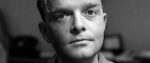 A black-and-white close-up photograph of author Truman Capote as a young man.