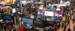 A birds-eye view of the PAX East 2024 show floor, featuring a zillion gaming-related booths and even more people milling around them.