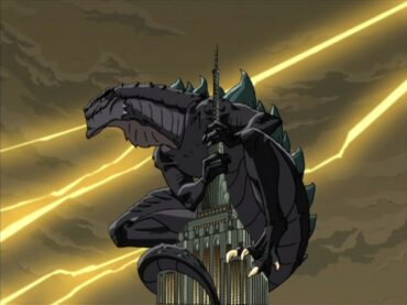 In a still from Godzilla: The Series, an animated Godzilla sits atop the Empire State Building, his body curled around the spire.